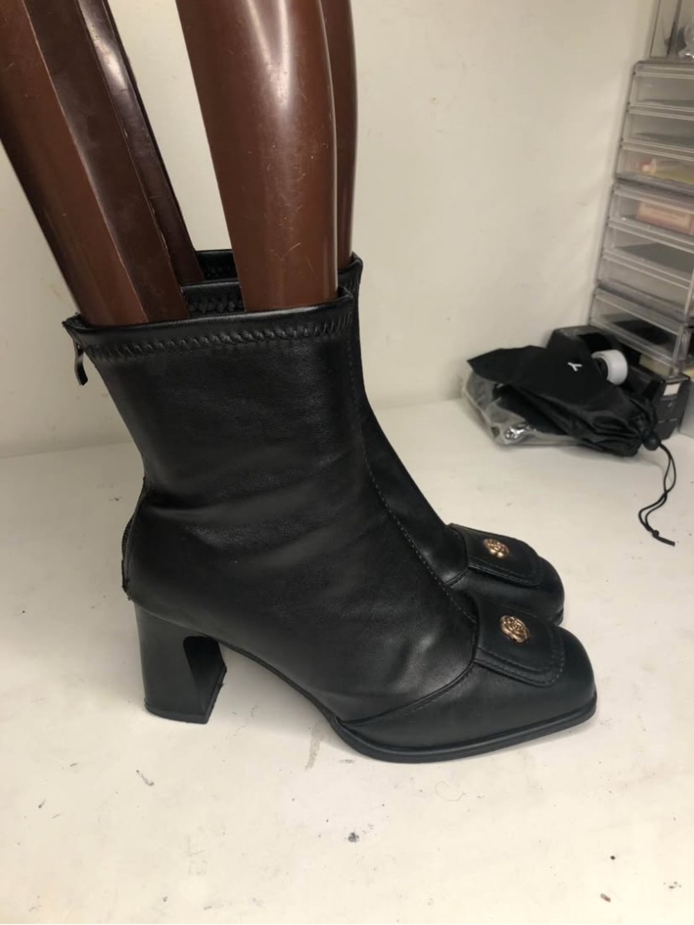 Black Mid-Calf Heeled Boots with Gold Emblem